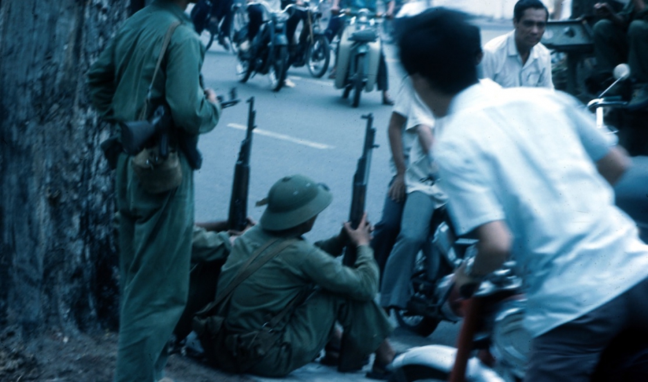 North Vietnamese troops and Saigon residents eye each other on the streets of the city on April 30th, 1975, the day the city fell to the government in Hanoi. 